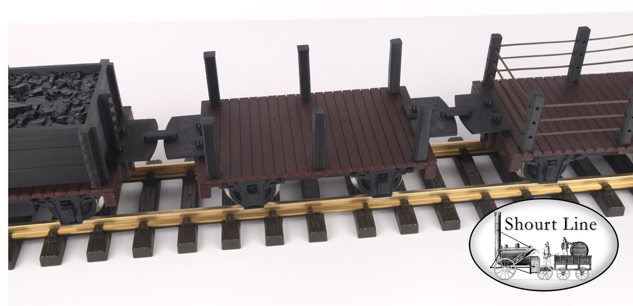 The SL 1008039 Gondola with an SL 2308001 Coal Load is on the left side, an optional SL 1001000 Flat Car w 6 Posts 39H mm (1.5") posts shown in the center and on the right side is an optional SL 1001200 Flat Car w 6 Posts & 3 Level Rope Fence.